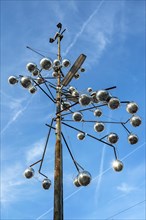 Pole of a street light as a work of art with disco balls