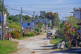 Dirt road running through rural village in the countryside of the Villa Clara Province on the island Cuba