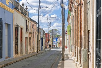 Narrow street with houses in Spanish colonial style in the old town centre of the city Camagueey on the island Cuba