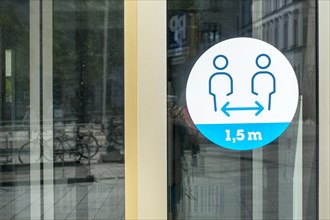 Sticker on shop window indicating to keep social distance of 1. 5 metres during 2020 COVID-19