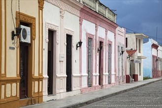 Pastel coloured houses in colourful colonial street in Bayamo