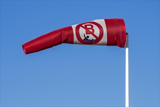 Blowing red and white windsock with no swimming