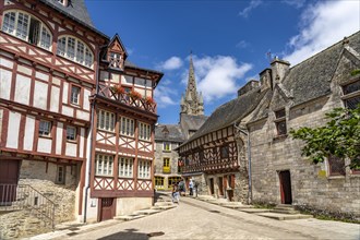 Half-timbered houses and the Basilica Notre-Dame-du-Roncier in the old town of Josselin