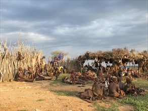 Villagers from the Hamar tribe sitting on the ground