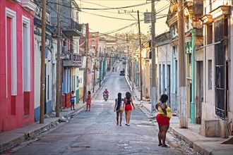 Afro-Cuban women walking street at sunset in the colonial city center of Matanzas on the island Cuba