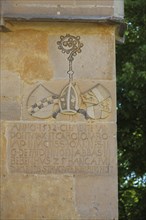Coat of arms and inscription on castle wall