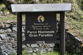 Wooden welcoming board with logo of the Gran Paradiso National Park in the Graian Alps