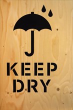 Wooden packaging box crate with keep dry text and umbrella sign