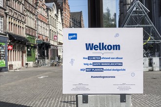 Welcome and instruction sign at entrance of shopping street during the 2020 COVID-19