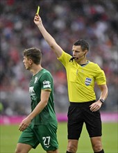 Referee Daniel Siebert shows Arne Engels FC Augsburg FCA