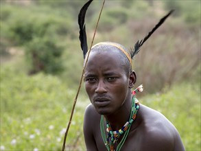 Young man from the Hamar tribe with feather headdress