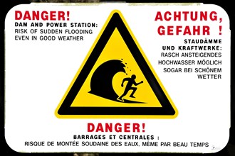 Warning sign for sudden flooding of river by dam from power station