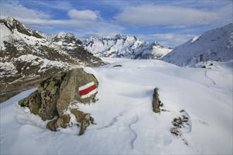 Characteristic white and red stripes on rock marking a GR long-distance footpath in the Swiss Alps at Wallis