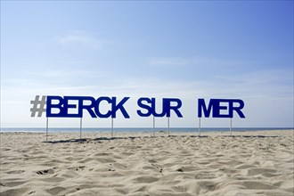 Sign with big letters on sandy beach at seaside resort Berck