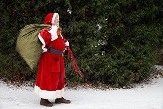 Father Christmas with gifts backpack on his back