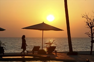 Parasol and woman in evening sun