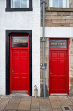 Two red front doors in the fishing village of Pittenweem