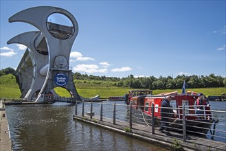 Canal boat with tourists mooring at Falkirk Wheel