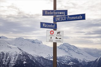 Signpost and warning sign in the Swiss Alps near Riederalp
