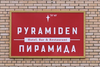 Red sign on wall of hotel bar restaurant at Pyramiden