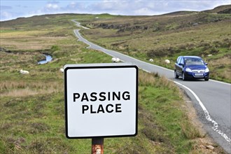 Traffic sign along single track road with passing places on the the Isle of Skye