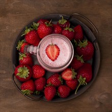 Flat lay strawberry milkshake with fruit