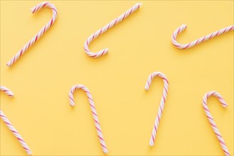 Christmas candy canes yellow background