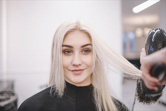Content woman enjoying salon hairstyle