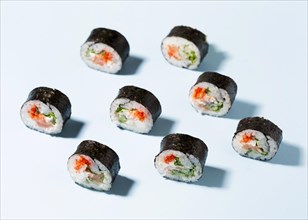 Delicious sushi rolls aligned table