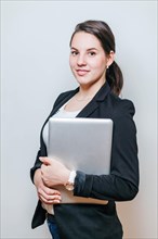 Office worker standing with laptop