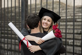 Couple hugging graduation