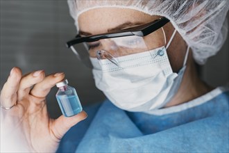 Doctor holding vaccine bottle