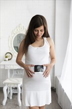 Woman showing ultrasound her baby