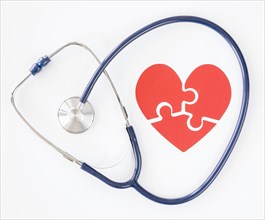 Top view stethoscope with puzzle paper heart