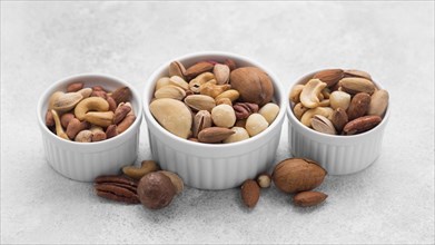 White small bowls filled with assortment nuts