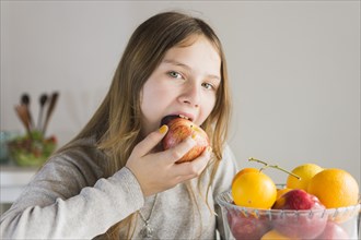 Portrait girl eating red apple