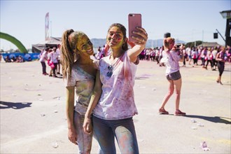 Portrait smiling young women taking selfie mobile phone