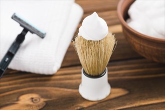 White foam shaving brush with razor napkin foam desk