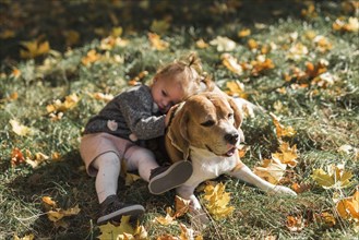 Girl lying her beagle dog park