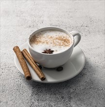 High angle coffee cup with cinnamon sticks star anise