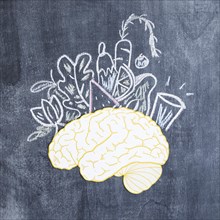 Mixed drawn vegetables paper cutout brain chalkboard