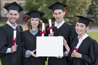 Graduation concept with students holding blank certificate template