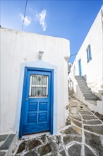 White Cycladic houses with blue windows and doors