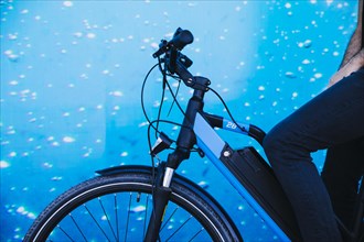 Close up cyclist e bike with aquarium background
