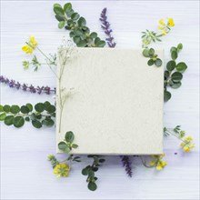 Wooden white blank frame flowers leaves textured background