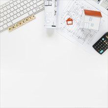 Keyboard with house model blueprint real estate office desk