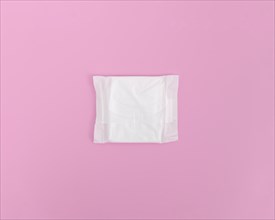 Closed sanitary towel pink background