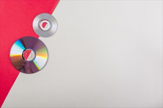 Overhead view compact discs red white dual background