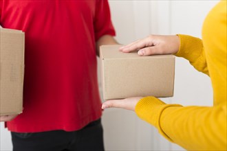 Woman taking package from delivery man