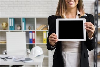 Smiley woman holding tablet mockup